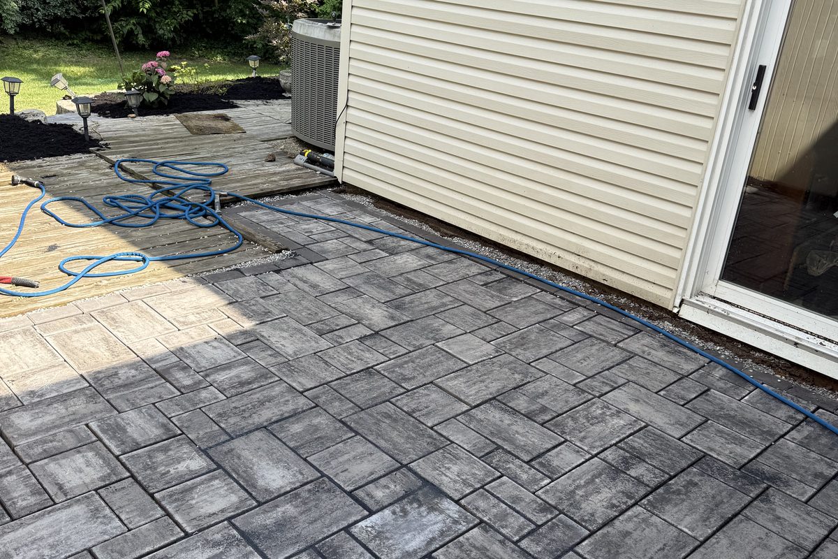 Paver patio and outdoor living space on a sloped Cincinnati backyard